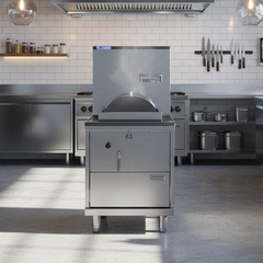 Modern industrial kitchen with stainless steel appliances and white tiled walls.